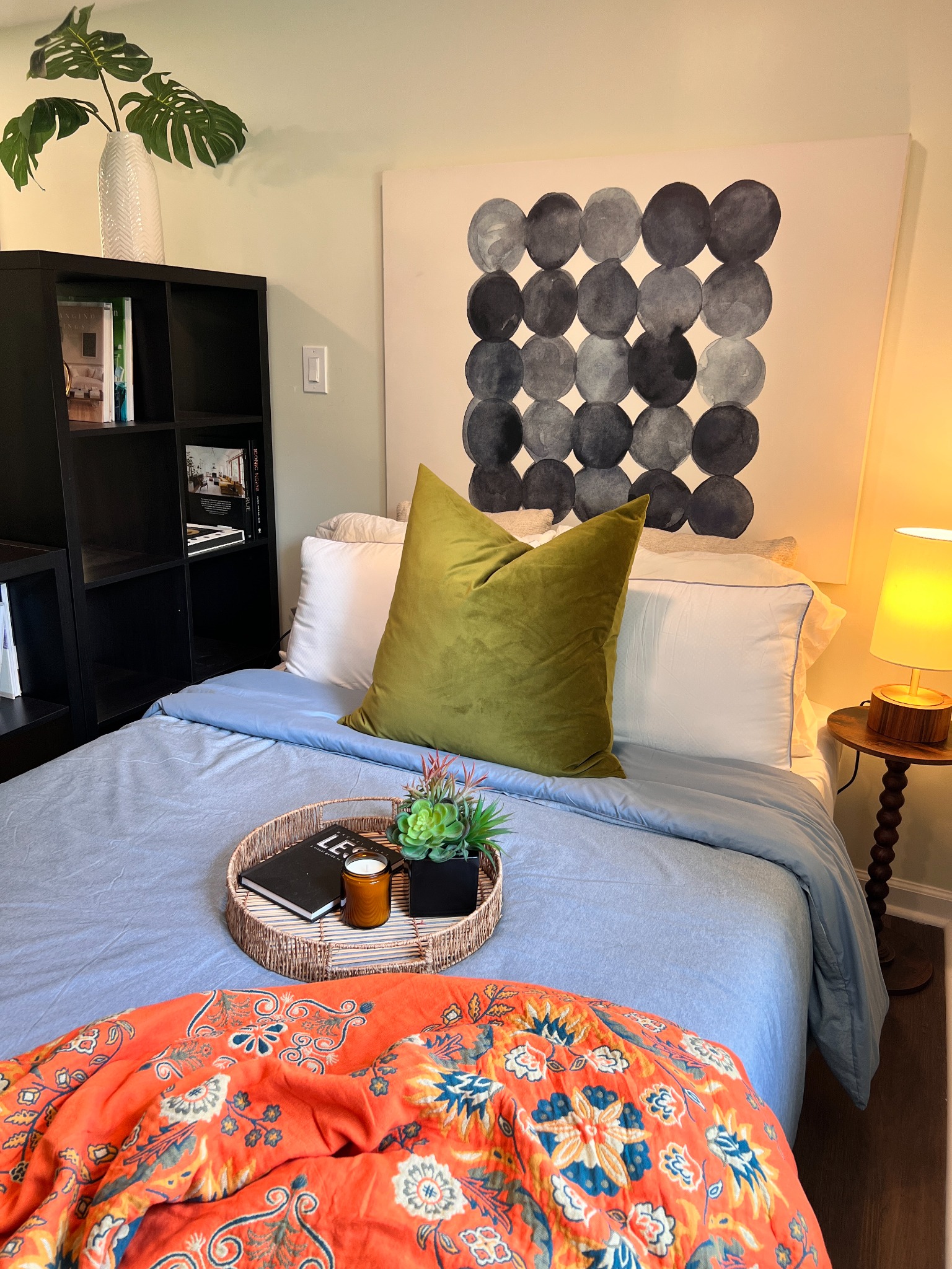 Guest bed with original artwork and colorful textiles