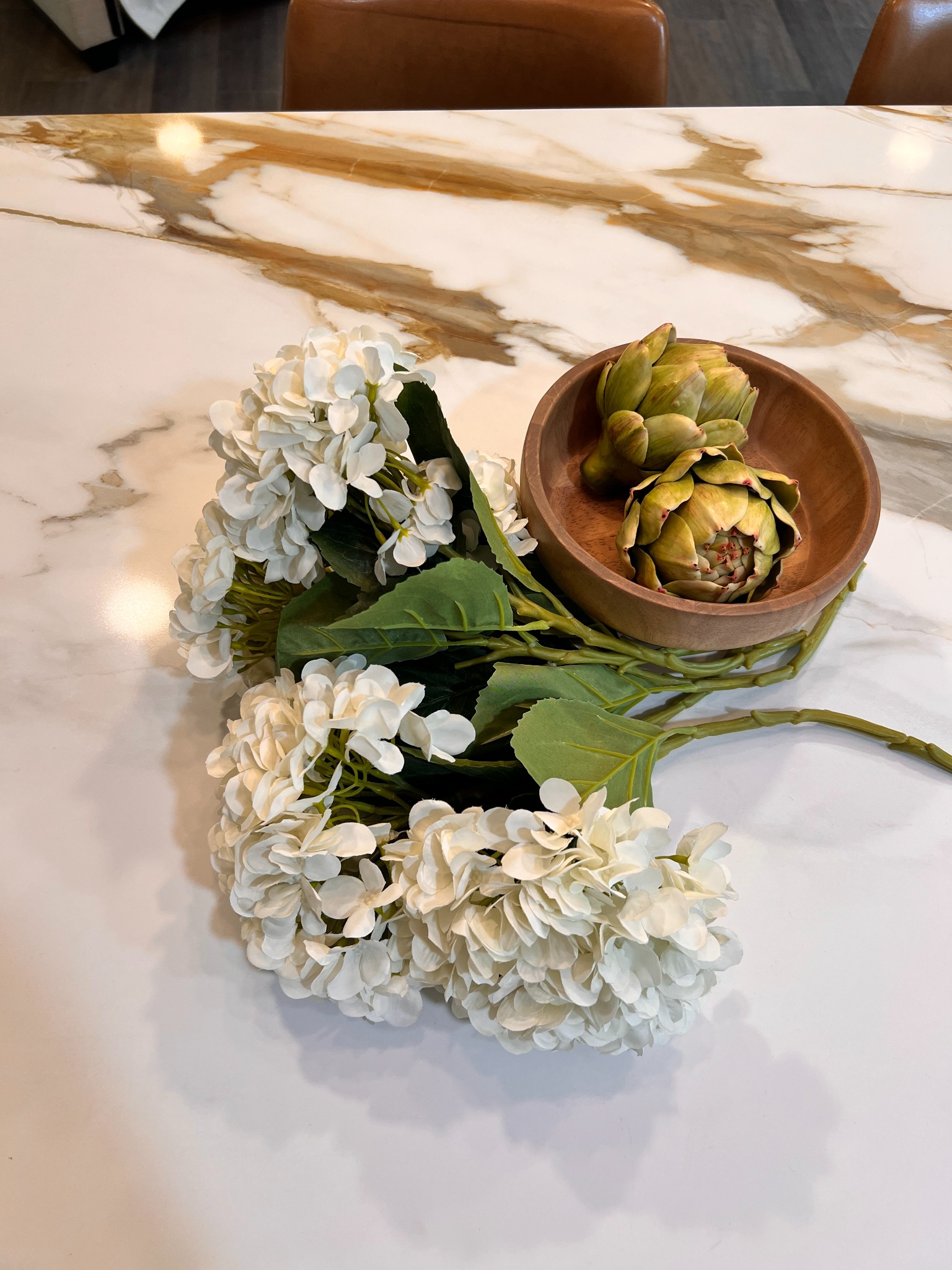 Hydrangeas and artichokes styled on the kitchen countertop